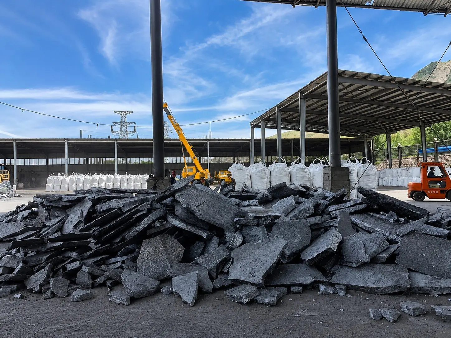bulk ferrosilicon fesi alloy lumps in factory storage yard with bulk bags and crane